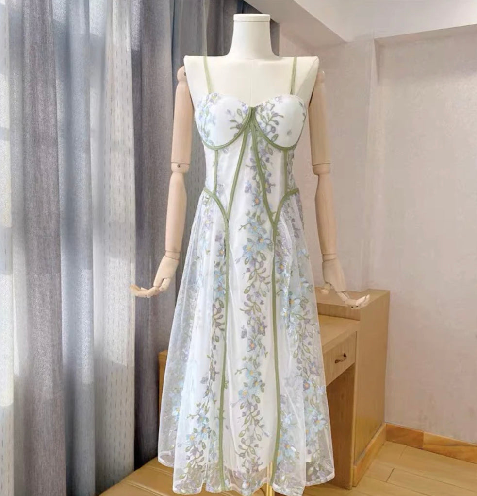 Romantic white corset midi dress with blue floral embroidery and feminine silhouette