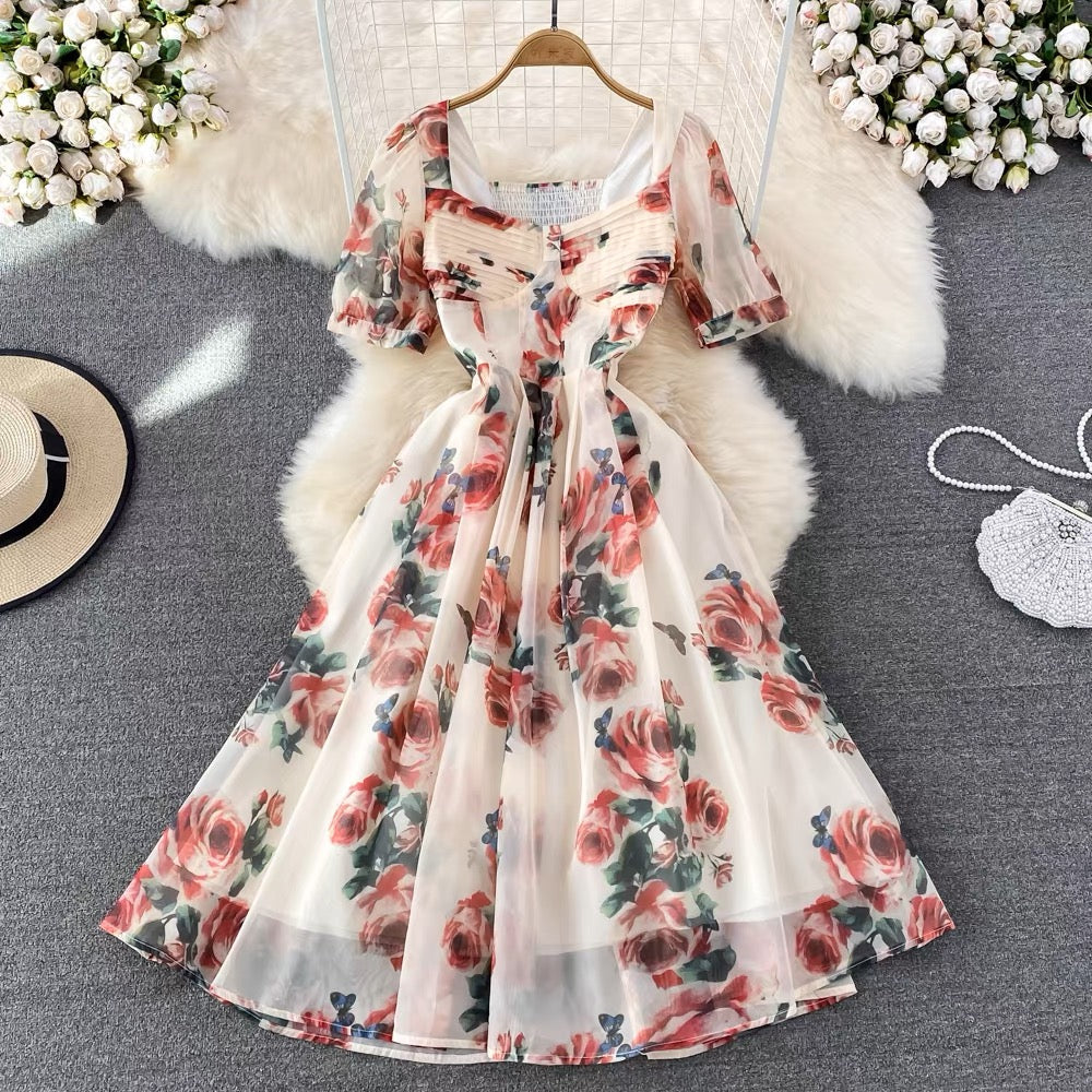 Elegant ivory floral midi dress featuring pink rose prints, square neckline, pleated bust
