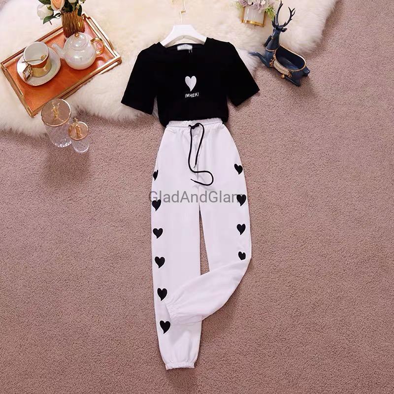 Charlotte Heart Print Co-Ord Set flat lay featuring a white graphic t-shirt and pink heart print jogger pants for women